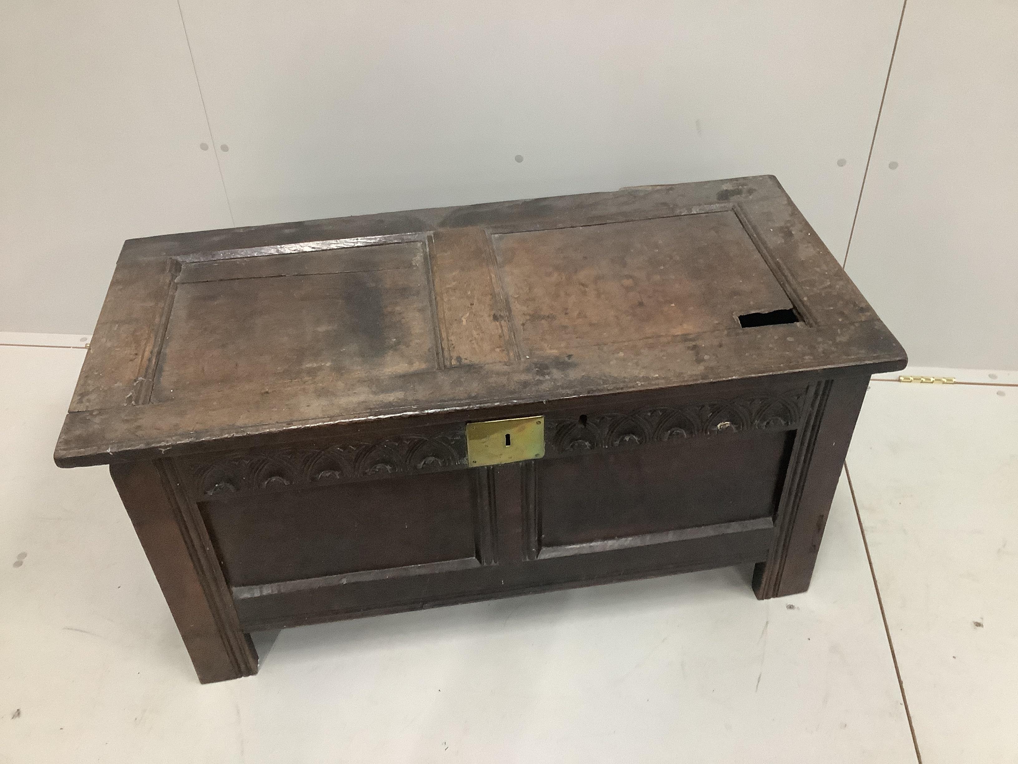 A 17th century panelled oak coffer, width 104cm (hole in top panel)